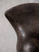 Close-up on the ML 42 Counter Stool's dark wood seat, revealing the intricate patterns of the wood grain and its curved edge.