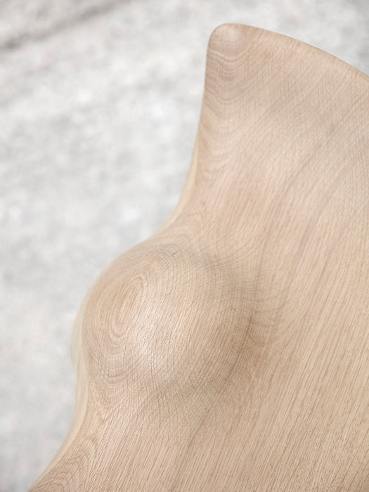 A close-up detail of the ML 42 Counter Stool, showing the beautiful grain and sculptural curves of the soap-treated oak wood.