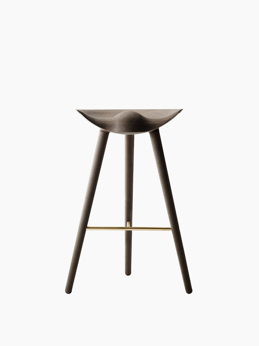 Front view of the ML 42 Counter Stool in dark smoked oak. The three-legged stool has a sculptural seat and a brass footrest.