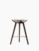 Front view of the ML 42 Counter Stool in brown oiled oak. The stool has a sculpted seat, three legs, and a copper footrest.