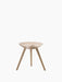 Front view of the ML 42 Stool in Soap Treated Oak. It has three splayed legs and a uniquely sculpted, contoured seat.
