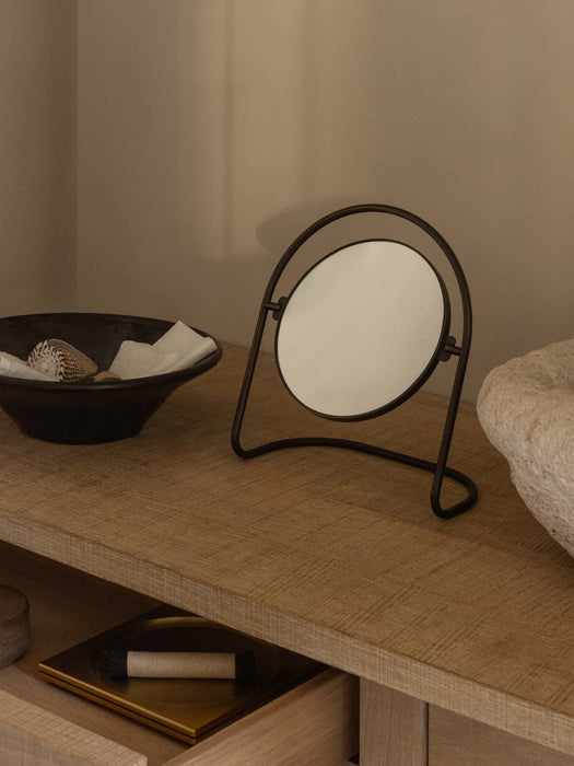 A Nimbus Table Mirror sits on a wooden console table next to a Triptych Bowl, with an open drawer revealing a Divot Tray.