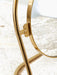 A detailed close-up of the Nimbus Table Mirror, showing the polished brass hinge connecting the circular mirror to its stand.