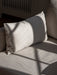 Detailed shot of the Offset Sofa's cushion, showing its light, textured loose cover with sunlight and shadow play across it.