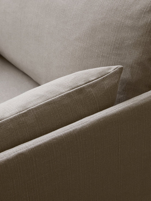 A close-up of the Offset Sofa w. Loose Cover, highlighting the textured weave and neat stitching of its light brown fabric.