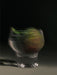 A moody, artistic photo of a fig submerged in a glass of water against a dark background for the Midnight Soak candle.