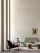 A minimal living room with the grey Pagode Sofa, Elizabeth Lounge Chair, Androgyne Table, and Plinth with Reverse Lamp.