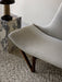 A close-up of the light grey Pagode Sofa on a textured rug, next to a marble Plinth Tall table with a Reverse Table Lamp.