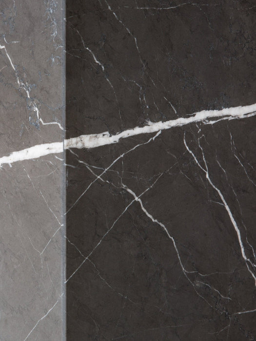 A close-up of the join between a grey marble and a dark charcoal marble slab, showing material options for the Plinth Low.