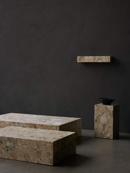 Minimalist composition of marble furniture: Plinth Low, Plinth Grand, Plinth Tall with a Triptych Bowl, and a Plinth Shelf.