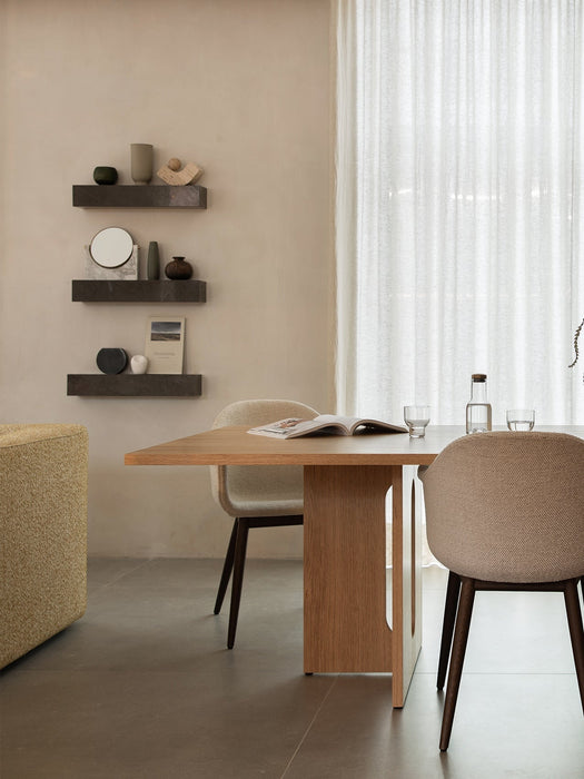 Androgyne Dining Table and Harbour Chairs in a dining room. Plinth Shelves display a Pepe Marble Mirror and Cyclades vase.