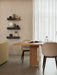 Androgyne Dining Table and Harbour Chairs in a dining room. Plinth Shelves display a Pepe Marble Mirror and Cyclades vase.