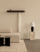 A serene living room setting featuring the cream Eave Modular Sofa, black Androgyne Side Table, and Epoch Shelf on the wall.
