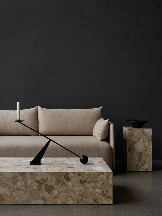 A living room scene with an Offset Sofa, Plinth Grand, Plinth Tall, Interconnect Candle Holder, and Triptych Bowl.