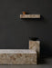 A setting of Plinth Low, Plinth Tall, and Plinth Shelf in patterned marble against a dark wall, styled with a Triptych Bowl.