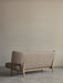 Back view of the Radiohus Sofa P2, showing its curved design with light brown upholstery and natural oak frame.