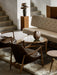 A styled living room featuring the beige tufted Radiohus Sofa P3, two leather armchairs and a glass-topped coffee table.