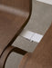 A close-up, overhead view of the silver row-connecting feature linking two dark oak Ready Dining Chairs against a grey floor.