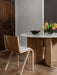 A Ready Dining Chair in light oak at an Androgyne Dining Table with a marble top, styled with a Triptych Bowl and Aer Vase.