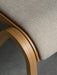 Close-up of the Ready Dining Chair's seat, showing the beige woven upholstery and the grain of the curved oak frame.