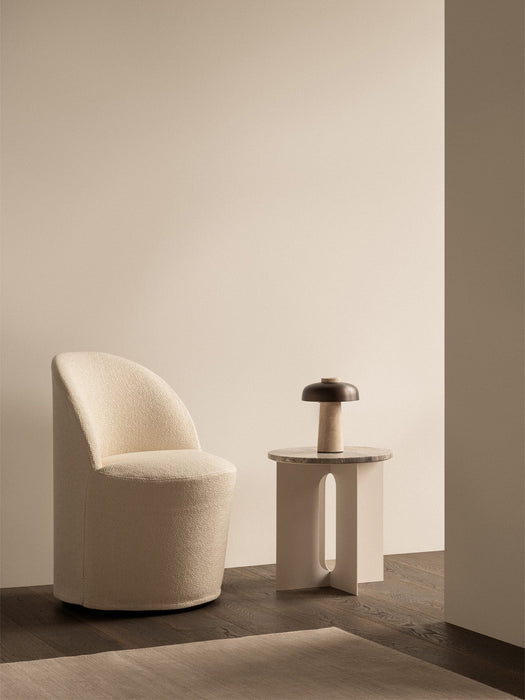 A cream Tearoom Club Chair, Androgyne Side Table, and a portable Reverse Table Lamp in a serene, minimalist setting.