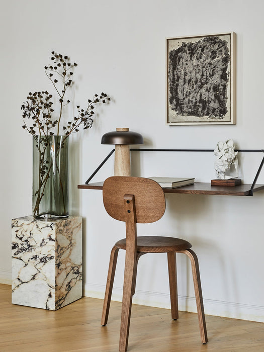 A styled corner with a Rail Desk, an Afteroom Chair, and a marble Plinth. The Reverse Table Lamp sits on the desk.