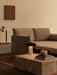 The Reverse Table Lamp sits on a Plinth Low coffee table next to an Offset Sofa Bed on a Duomo Rug in a modern living room.