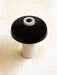 A high-angle view of the Reverse Table Lamp, with a glossy black shade, white marble base, and marble dimmer switch.