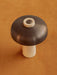 Top-down view of the Reverse Table Lamp, highlighting its bronzed shade, travertine base, and dimmer on an ochre surface.