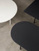 An overhead view of the Snaregade table collection, featuring an oval, a round, and a rectangular table in black and white.