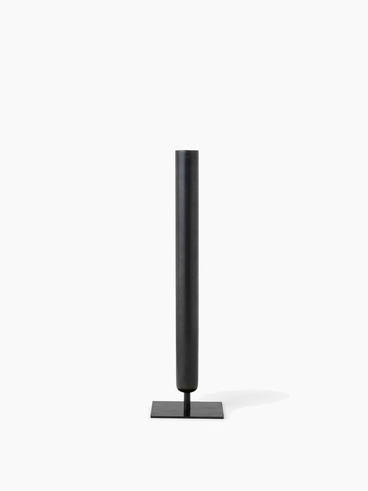 A tall, slender Stance Vase H40 in a bronzed brass finish, with a long tubular body and a flat, square base.