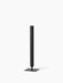 An angle view of the Stance Vase in bronzed brass. The tall vase has a slender cylindrical shape and a flat square base.