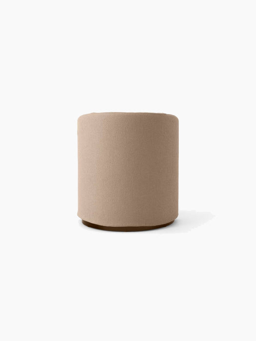 The Tearoom Club Chair's light brown Logan fabric, shown on a cylindrical pouf against a white background.