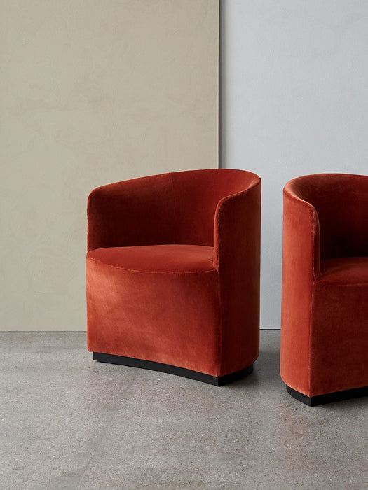 Two Tearoom Club Chairs in burnt-orange velvet fabric, in a minimalist room with a terrazzo floor and a two-toned wall.