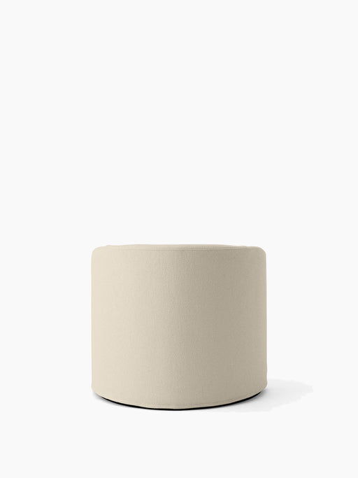 A cylindrical pouf upholstered in the textured, off-white Logan Jasmine fabric, an option for the Tearoom Lounge Chair.