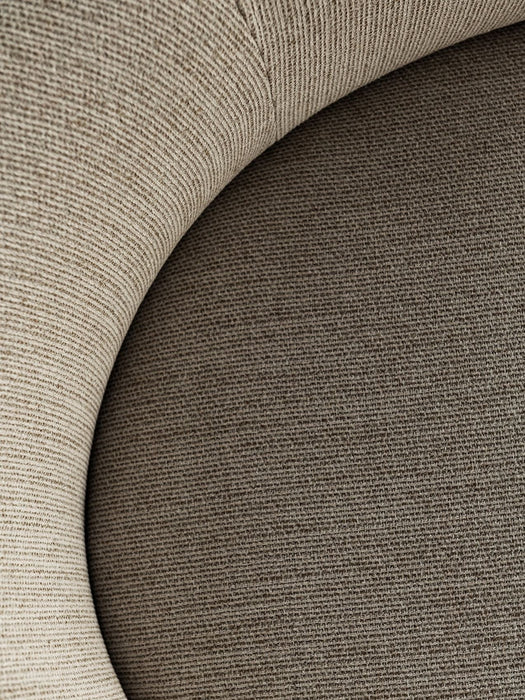A close-up of the Tearoom Lounge Chair's upholstery, contrasting its light beige ribbed and darker woven fabrics.