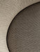 A close-up of the Tearoom Lounge Chair's upholstery, contrasting its light beige ribbed and darker woven fabrics.