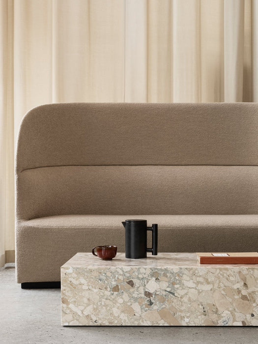 The beige, textured Tearoom Sofa, High Back sits behind a terrazzo Plinth coffee table with a black Yana Brewing Pot and cup.