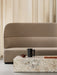 The beige, textured Tearoom Sofa, High Back sits behind a terrazzo Plinth coffee table with a black Yana Brewing Pot and cup.