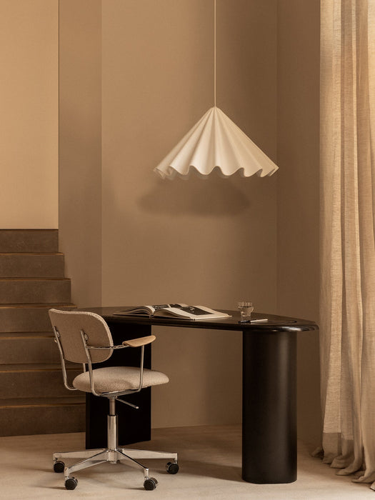 The black Eclipse Desk is paired with a Co Task Chair under a white Dancing Pendant lamp in a softly lit, neutral-toned room.