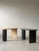 Two The Eclipse Desks, one in natural oak and one in black lacquered oak, shown side-by-side in a minimalist space.