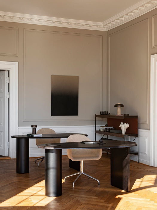 Two Eclipse Desks in black lacquered oak, in an office setting with beige walls, classic panelling, and parquet floors.