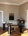 Two Eclipse Desks in black lacquered oak, in an office setting with beige walls, classic panelling, and parquet floors.