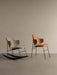 A light grey fabric Penguin Rocking Chair next to a tan leather Penguin Dining Chair, both with black frames.