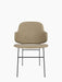 A front view of The Penguin Dining Chair, fully upholstered in a beige fabric with a thin, black powder-coated steel frame.
