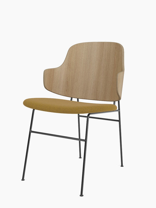 The Penguin Dining Chair shown at an angle, with a natural oak curved back, mustard yellow Re-Wool seat, and slim black legs.