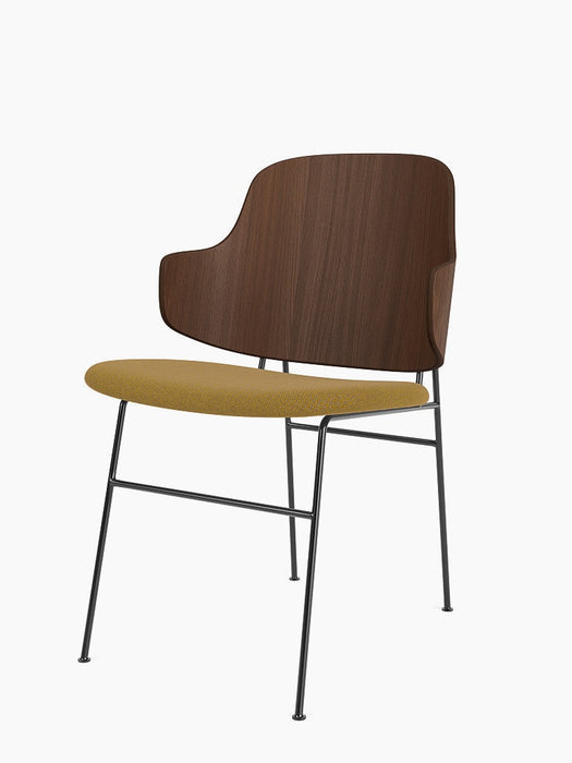 Angled view of The Penguin Dining Chair, with a walnut veneer backrest, a yellow Re-Wool seat, and a black metal frame.