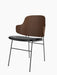 An angled view of the Penguin Dining Chair with its dark walnut veneer back, black leather seat, and slim black steel legs.