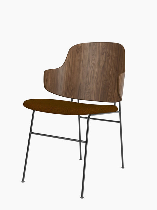 An angled view of The Penguin Dining Chair, showing its walnut veneer back, brown fabric seat, and slim black metal legs.
