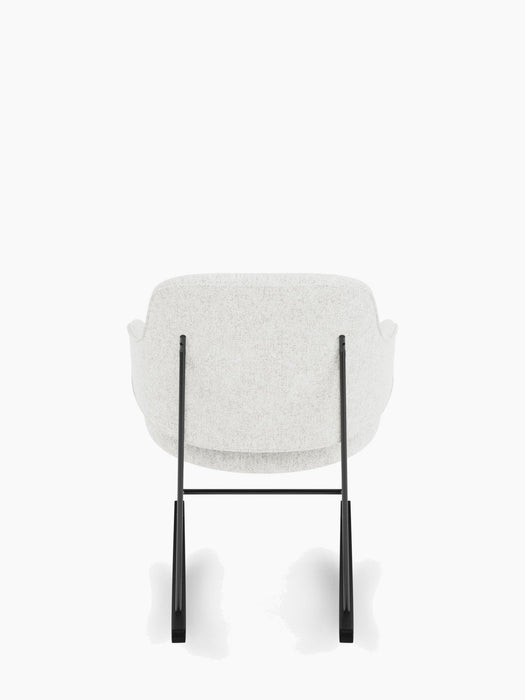 A back view of The Penguin Rocking Chair, showing its light grey upholstered seat and back on a slender black steel frame.